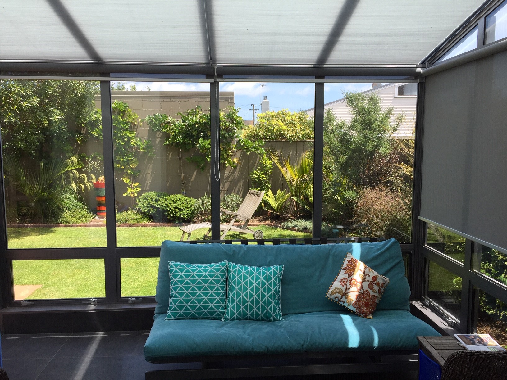 Sheltered garden room opening onto a planted Wellington back garden